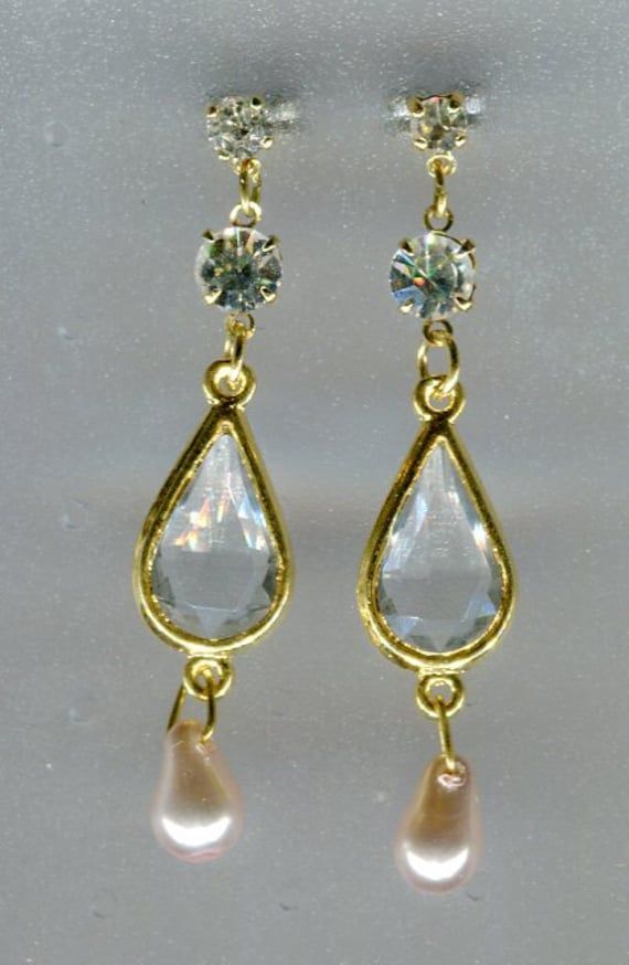 These earrings were built by me in Renaissance style from galvanical tinned brass pendants and ear hooks. Length: 50 mm incl. ear hooks Width: 10 mm Material: Brass with Bohemian rhinestone + glass Item code: M-V502 Party Jewelry With French Hook Dangle, Gold Teardrop Earrings As Gift, Gold Teardrop Earrings With Lever Back As Gift, Adjustable Gold Metal Chandelier Earrings, Teardrop Jewelry With French Hook For Party, Gold Chandelier Earrings As Gift, Adjustable Gold Chandelier Earrings For Gifts, Gold Drop Chandelier Earrings Gift, Gold Long Drop Pearl Earrings