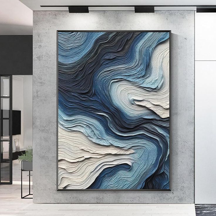 an abstract painting hangs on the wall in a modern room with white and blue decor