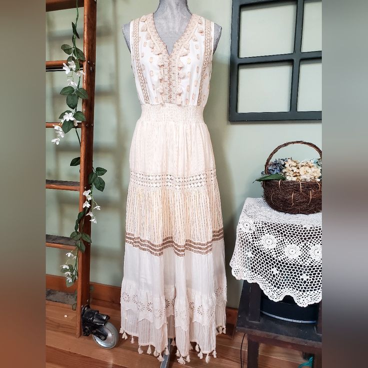 Such A Beautiful Bohemian Dress. 100% Cotton, Lightweight And Lined. Cream Color With Gold Designs. Wish I Could Keep It. Just Doesn't Fit Right. Bohemian Spring Midi Dress With Lace Trim, Bohemian Sleeveless Dress With Lace Trim, Beige Bohemian Midi Dress With Lace Trim, Bohemian Sundress With Lace Trim For Spring, Spring Bohemian Sundress With Lace Trim, Bohemian Sleeveless Boho Dress With Lace Trim, Bohemian Boho Dress With Lace Trim Sleeveless, Bohemian Cotton Maxi Dress With Lace Trim, Bohemian Cotton Midi Dress With Lace Trim