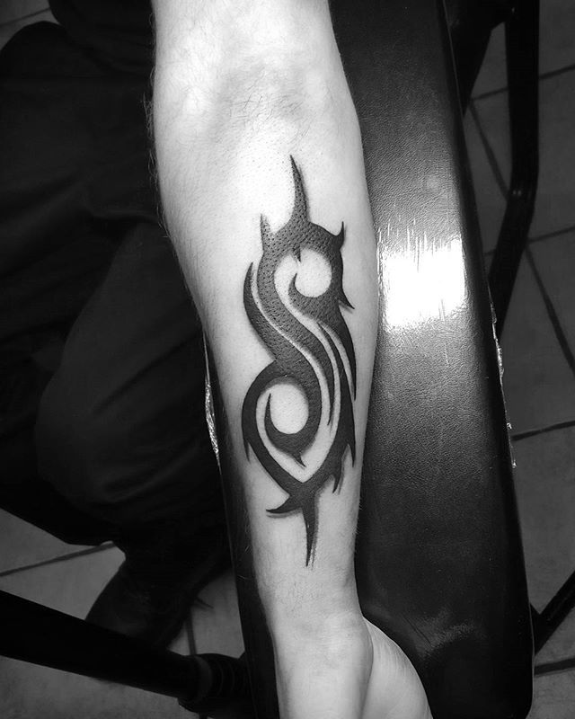 a black and white photo of a man's arm with a tattoo on it