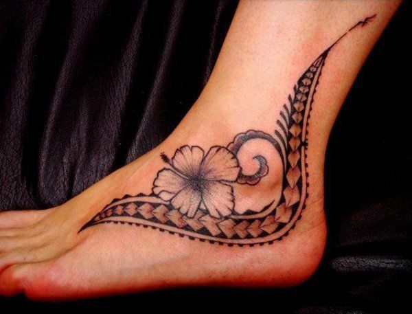 a woman's foot with a flower tattoo on it