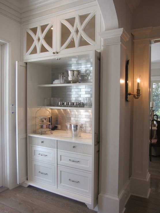 a kitchen with white cupboards and cabinets in it's centerpiece, next to an open door