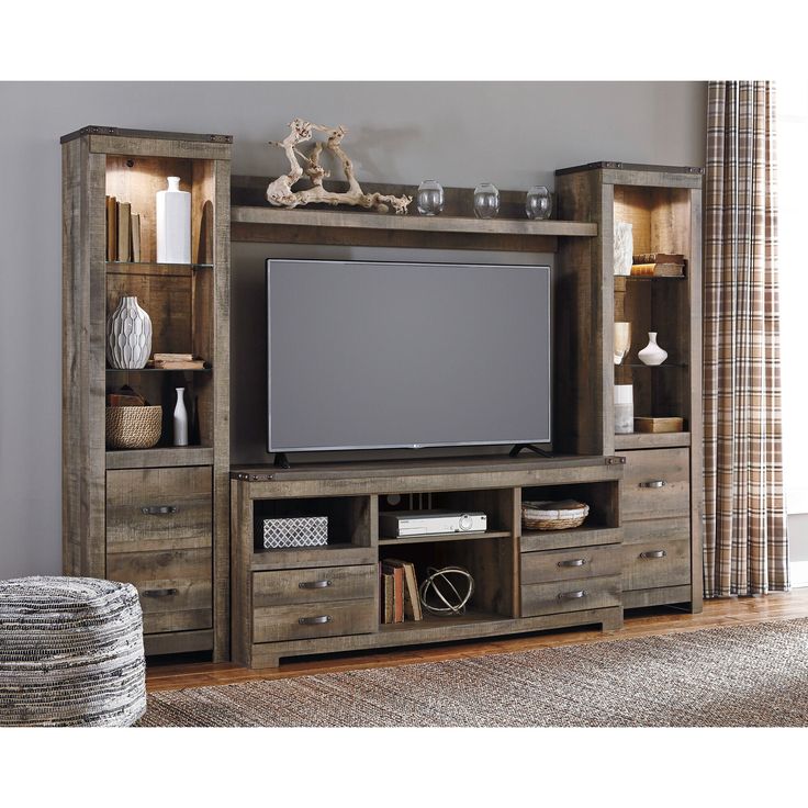 a large entertainment center with drawers and a flat screen tv mounted on it's side