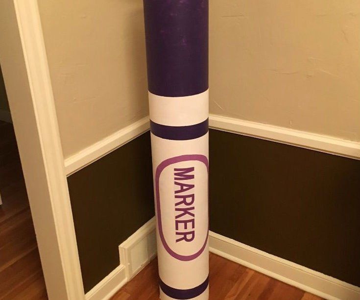 a purple and white tube sitting on top of a hard wood floor next to a wall