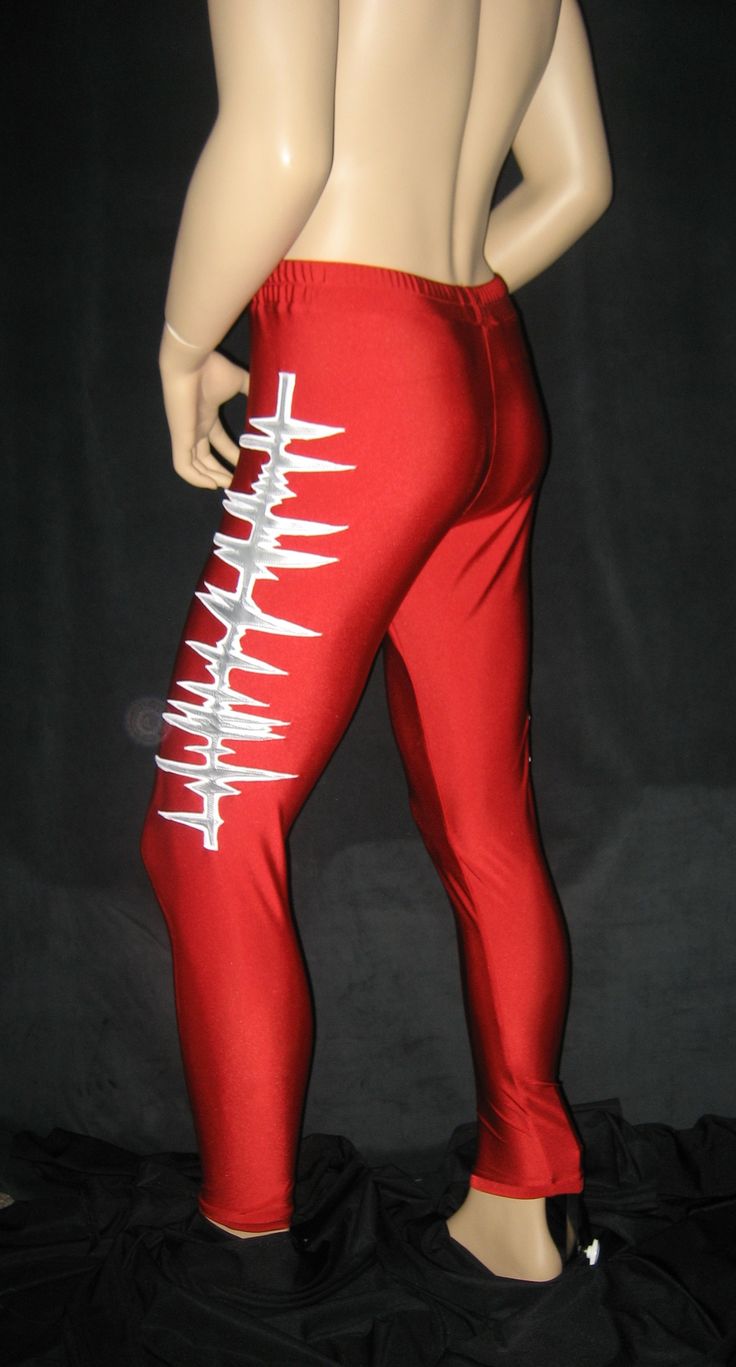 a mannequin wearing red pants with white writing on the leggings and back