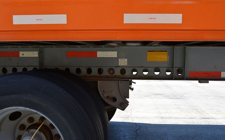 the rear end of a large truck parked in a parking lot