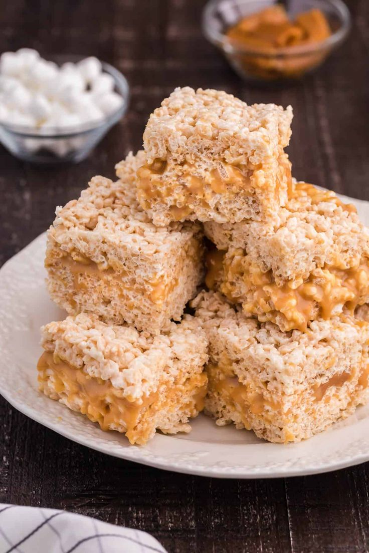 several pieces of rice krispy treats stacked on top of each other in a white plate