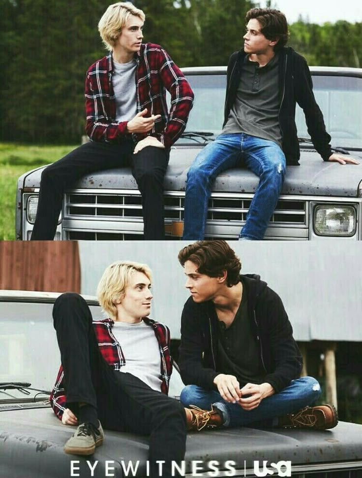 two young men sitting on the hood of a pickup truck, one with his hands in his pockets