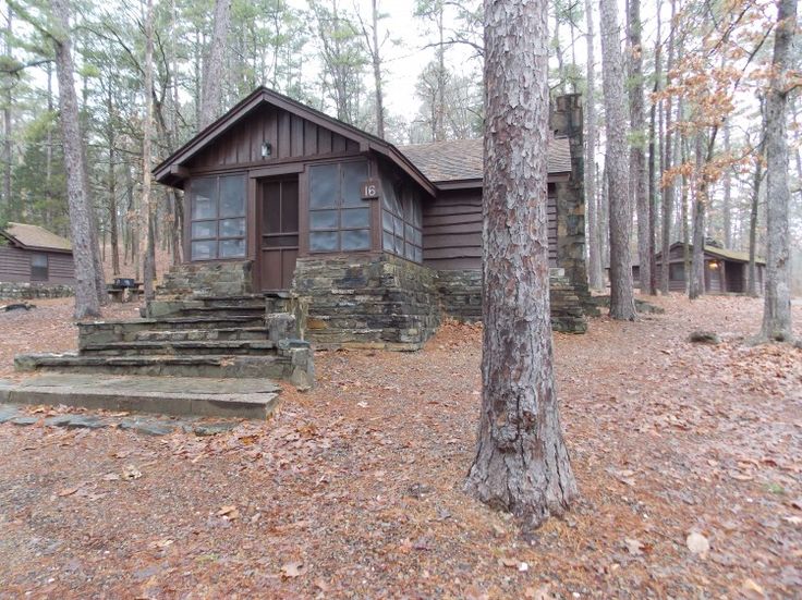 a cabin in the woods with steps leading up to it