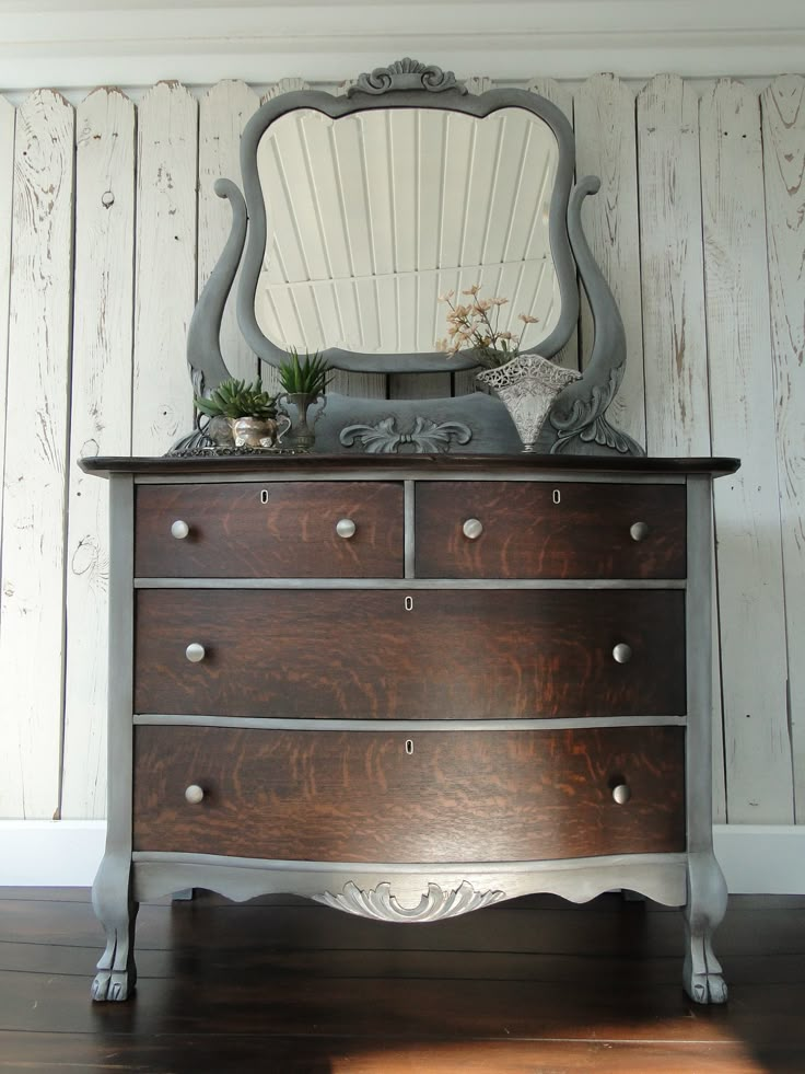 an old dresser with a mirror on top