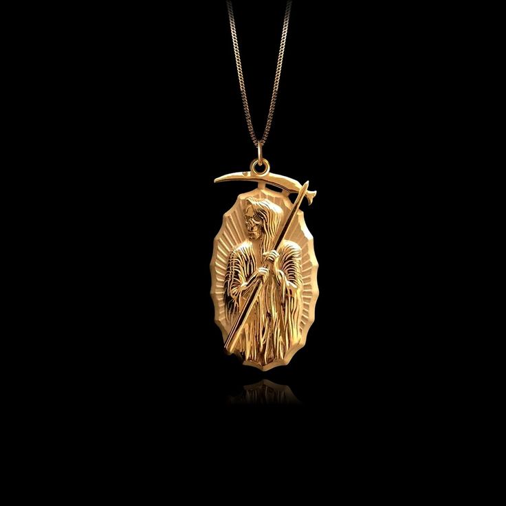 Our Gold Santa Muerte Pendant, crafted in the USA from real solid gold, embodies devotion and protection. This timeless piece showcases exquisite craftsmanship, designed to last a lifetime. Perfect for those seeking a unique and meaningful symbol, this pendant is a testament to enduring quality and elegance. PENDANT INFORMATIONThis pendant is made of real, solid gold.• Made in USA• Material: 14k or 18k solid gold• Finish: polished• Height: 1.28" (32,5 mm) x Width: 0.65" (16,5 mm)• Pendant weight Luxury Coin Pendant Jewelry As Gift, Timeless Gold Plated Coin Pendant Jewelry, Symbolic Pendant Jewelry That Is Tarnish Resistant, Symbolic Gold Plated Jewelry For Formal Occasions, Formal Symbolic Gold Plated Jewelry, Symbolic Pendant Jewelry Tarnish Resistant, Antique Gold Plated Round Pendant Jewelry, Symbolic Tarnish Resistant Yellow Gold Jewelry, Luxury Tarnish Resistant Cross Pendant Jewelry