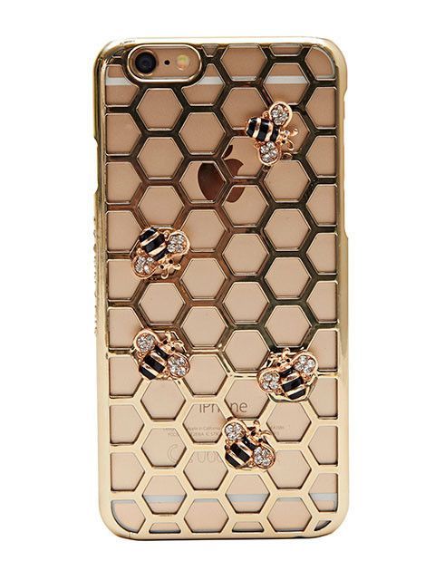 an iphone case with gold honeycombs and beehive charms on the back