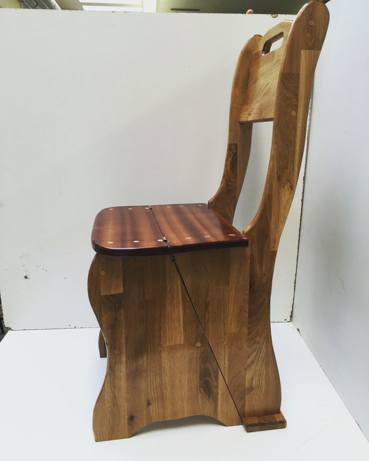 a wooden chair sitting on top of a white floor