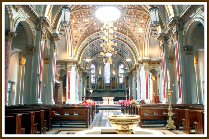 the inside of a church with pews and chandeliers on either side of the alter