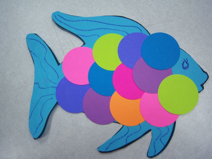 a paper cut out of a fish with circles on it's back and sides