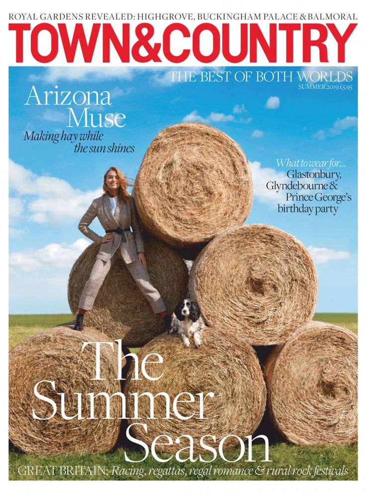 the front cover of town and country magazine with a woman standing on hay bales