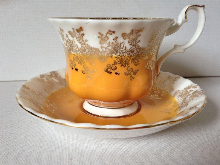 a tea cup and saucer sitting on a table