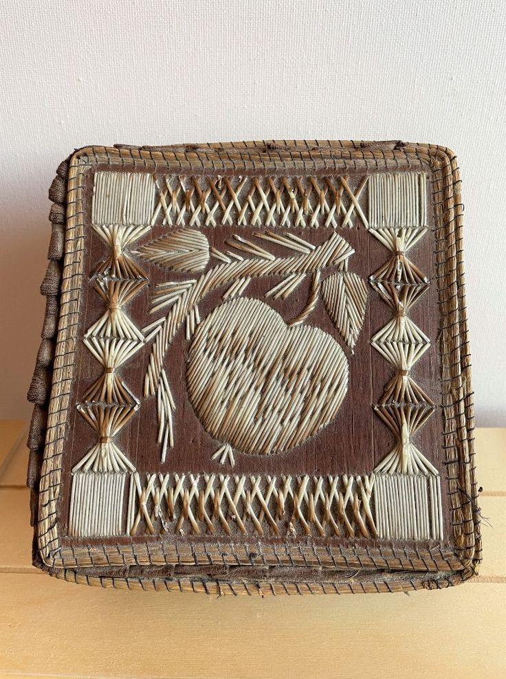 a woven basket with an apple on it