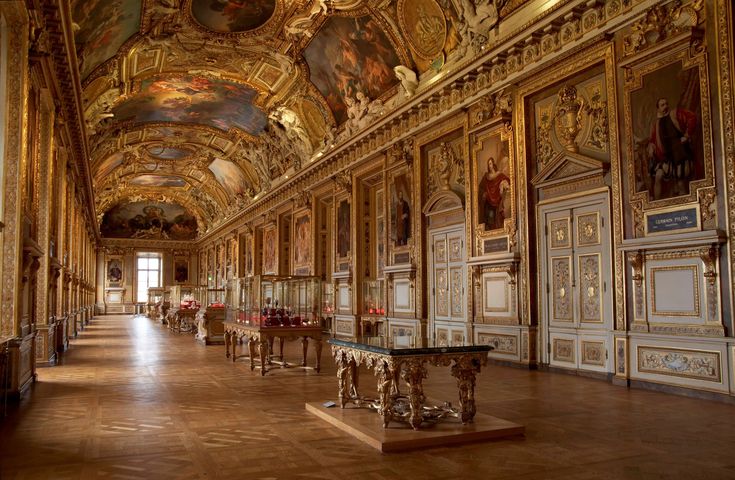 an ornately decorated room with many paintings on the walls