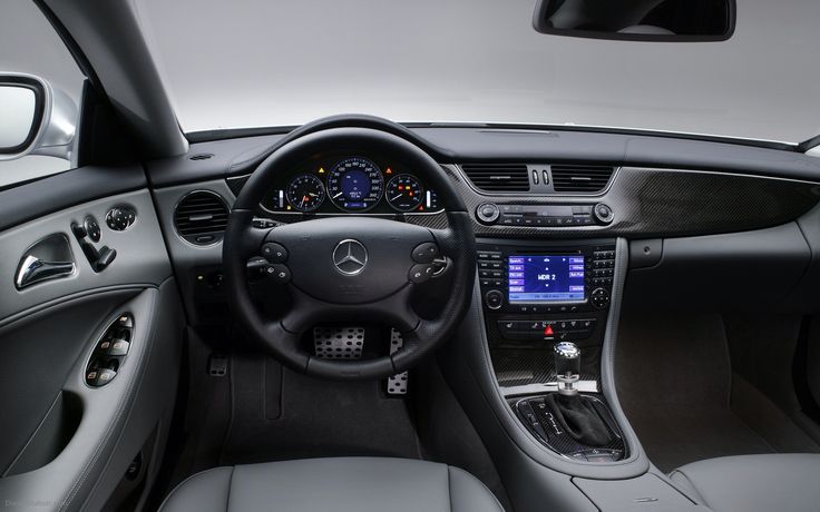 the interior of a car with dashboard lights and steering wheel controls, including an electronic display