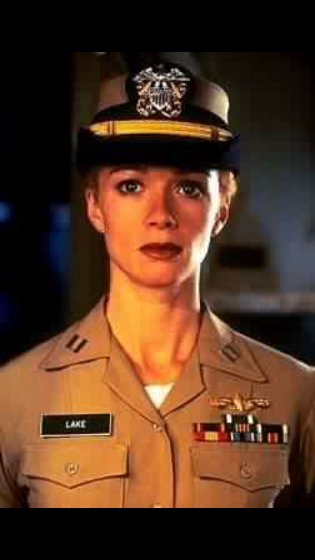 a woman in uniform is looking at the camera with an intense look on her face