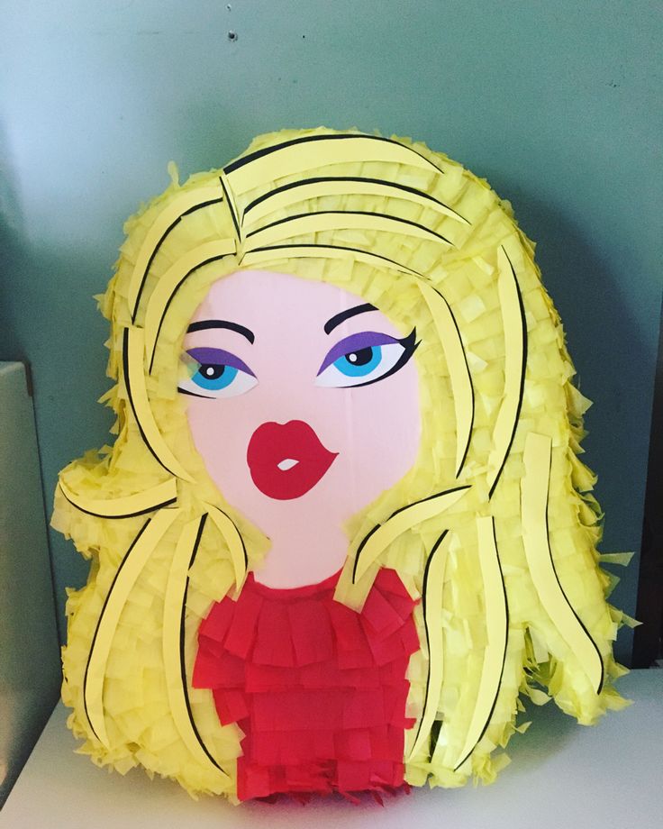 a yellow paper doll with blue eyes and blonde hair