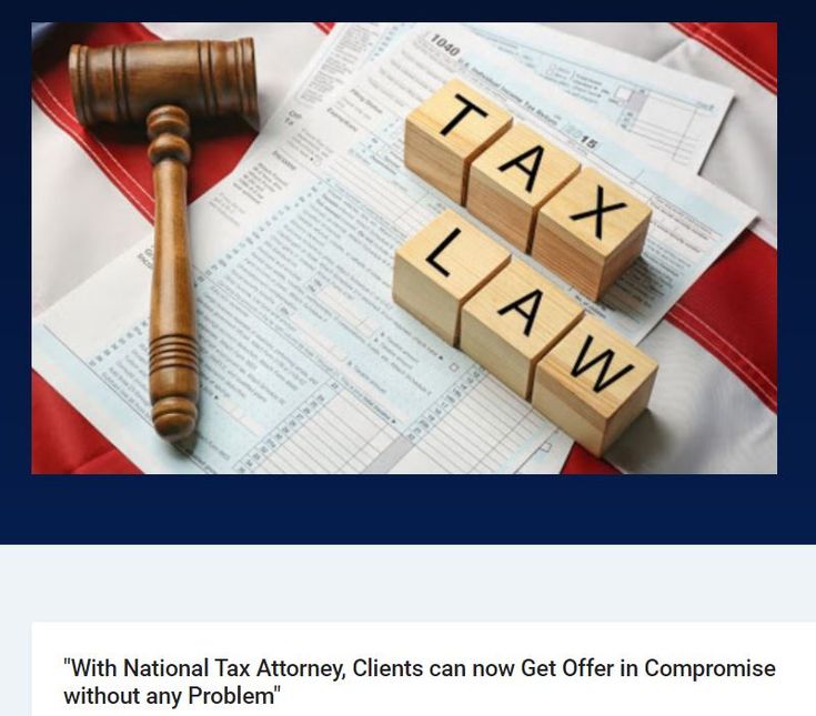 a wooden judge's hammer sitting next to tax law blocks on top of an american flag