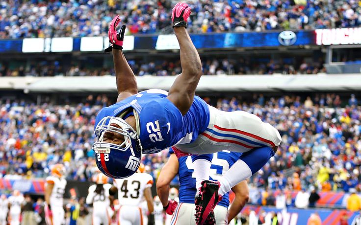 a football player is in the air with his feet up as he leaps into the air