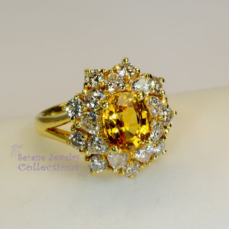 Thank you for coming in! This Vintage Ring has a strong striking yellow sapphire as its center piece. The sapphire is bezel set into a fancy setting with 8 heart and 8 round diamonds totaling 1.8 carats! Ring Size: 7.75 Total Weight: 9.58 grams Precious Metal: 18k solid gold Precious stones: -Yellow Sapphire: 2.92 carats, 9mm x 7.3mm -White Round Diamonds: 1.8 ct Hallmark: A18K Luxury Multi-stone Yellow Gemstones, Yellow Multi-stone Round Gemstones, Luxury Yellow Multi-stone Gemstones, Elegant Multi-stone Yellow Sapphire Jewelry, Elegant Yellow Sapphire Multi-stone Jewelry, Fine Yellow Oval Sapphire Ring, Elegant Yellow Oval Sapphire Ring, Yellow Sapphire Ring With Center Stone In Yellow Gold, Yellow Oval Sapphire Diamond Ring