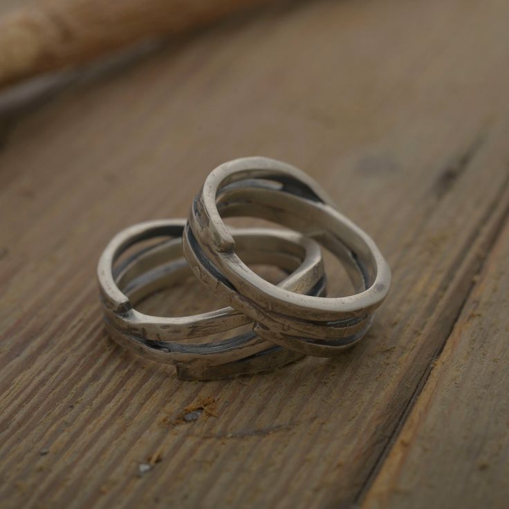 This bohemian style wedding band set is perfect for the couple who want to wear rings unconventional yet high quality. The width selected by the artisan is 8mm giving to both rings a unique appearance. The oxidized silver and the rather particular design symbolize the bond that strenghtens as time goes by. Your personal message can be hand stamped on the inside of both rings. Please write the message of your choice and your ring sizes in the Personalization box at checkout. The price is for the Rustic Hand Forged Promise Ring, Handmade Open Band Wedding Rings, Handmade Open Band Rings For Wedding, Bohemian Rings With Oxidized Finish For Anniversary, Bohemian Hand Forged Wedding Rings, Rustic Hand Forged Rings For Anniversary, Bohemian Adjustable Stackable Wedding Rings, Unique Handmade Stackable Wedding Rings, Handmade Unique Stackable Wedding Rings