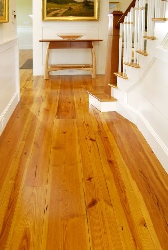 an empty room with wooden floors and stairs