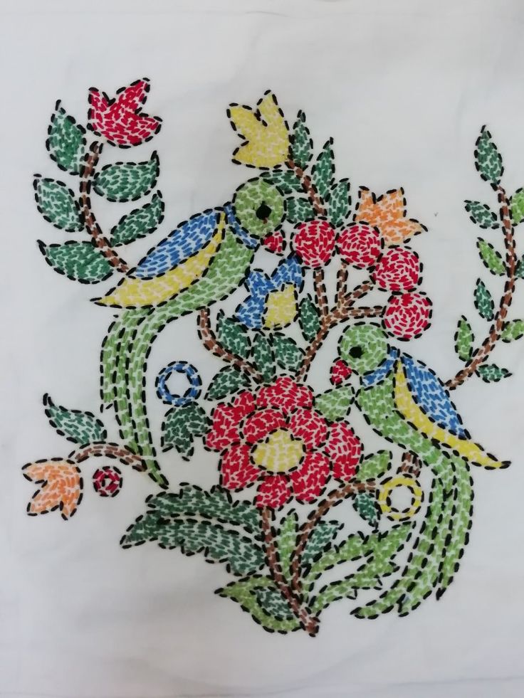 an embroidered piece of cloth with flowers and leaves