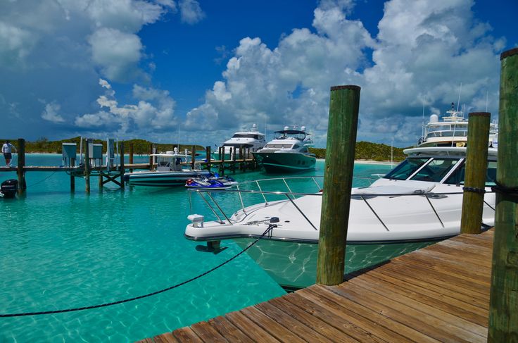 several boats docked at a pier on the water