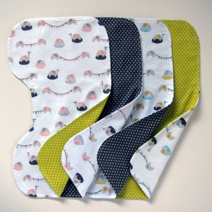 five baby bibs with different designs on them