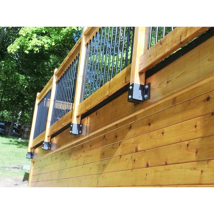 a wooden deck with metal railings on it