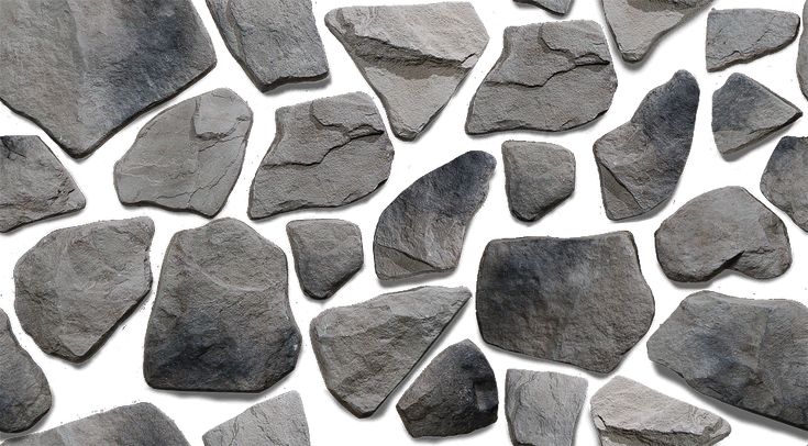 several gray rocks are arranged together on a white surface with no one in the photo