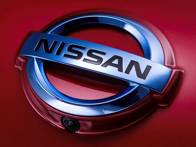 the nissan logo is shown on a red car