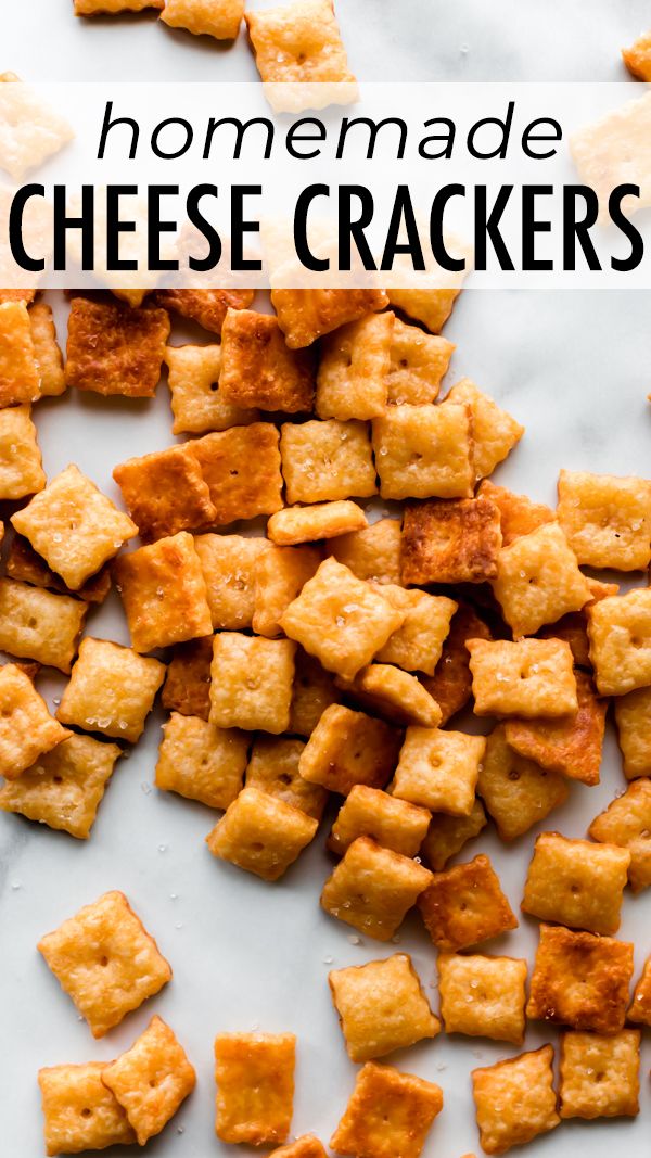 homemade cheesy crackers on a white surface with text overlay that reads homemade cheese crackers