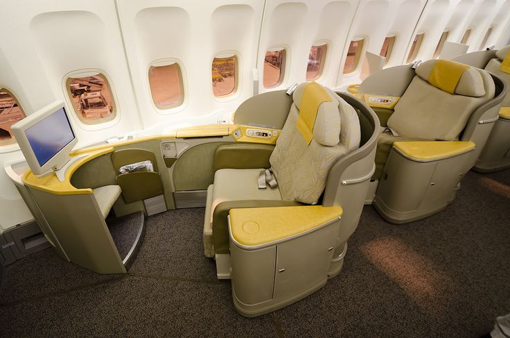 the inside of an airplane with yellow seats