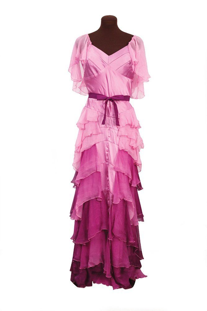 a woman's pink dress with ruffles on it