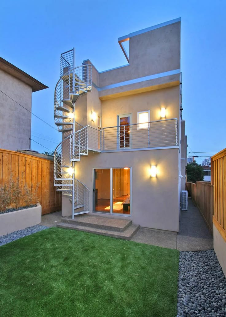 an apartment building with stairs leading up to the second floor