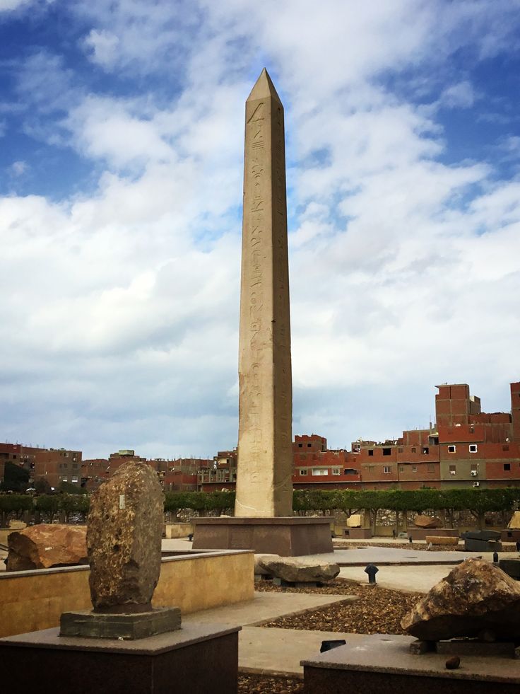 a tall obelisk in the middle of a courtyard