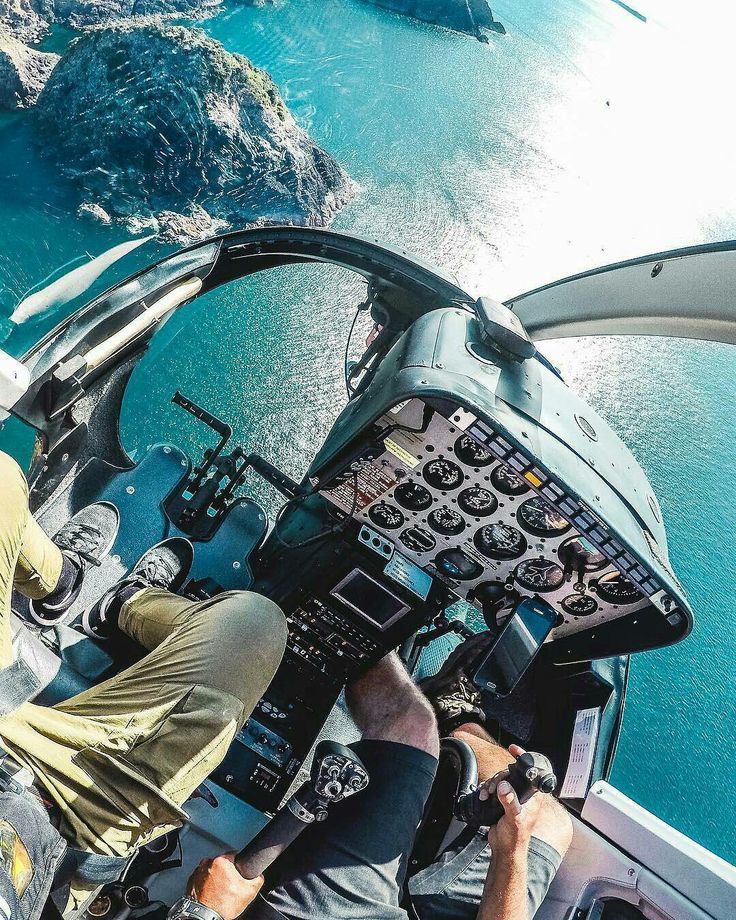 two men are sitting in the cockpit of an airplane