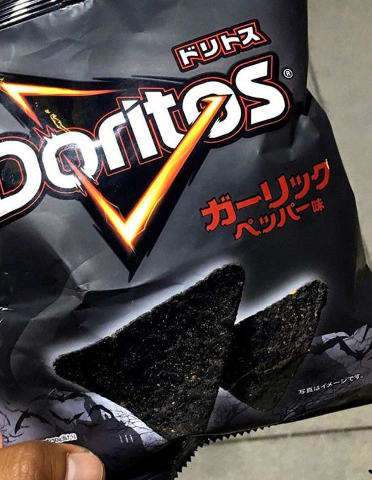 a person holding a bag of chips in their left hand with the word doritos written on it