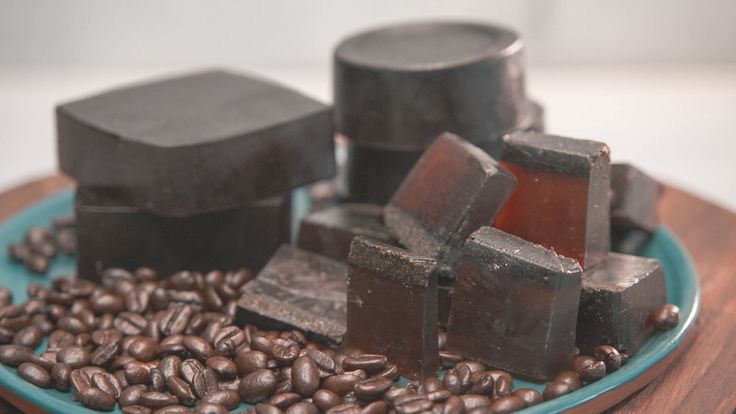 chocolates and coffee beans are on a plate with sugar cubes in the middle