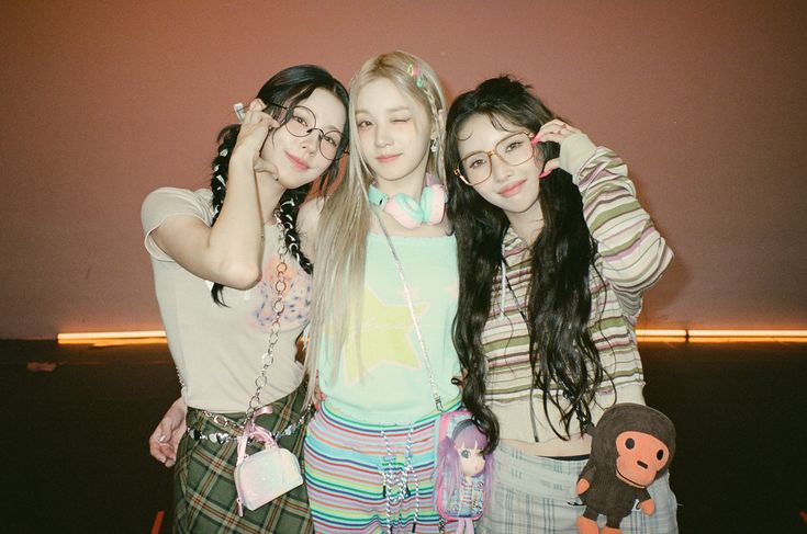 three girls are posing for the camera with their hair in braids and wearing glasses