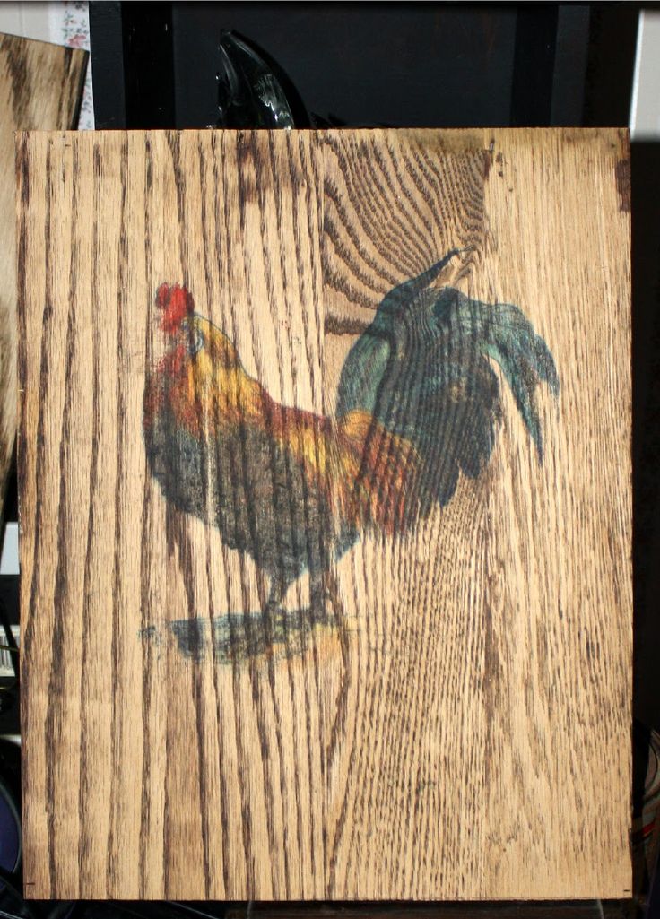 a wooden box with a rooster painted on it