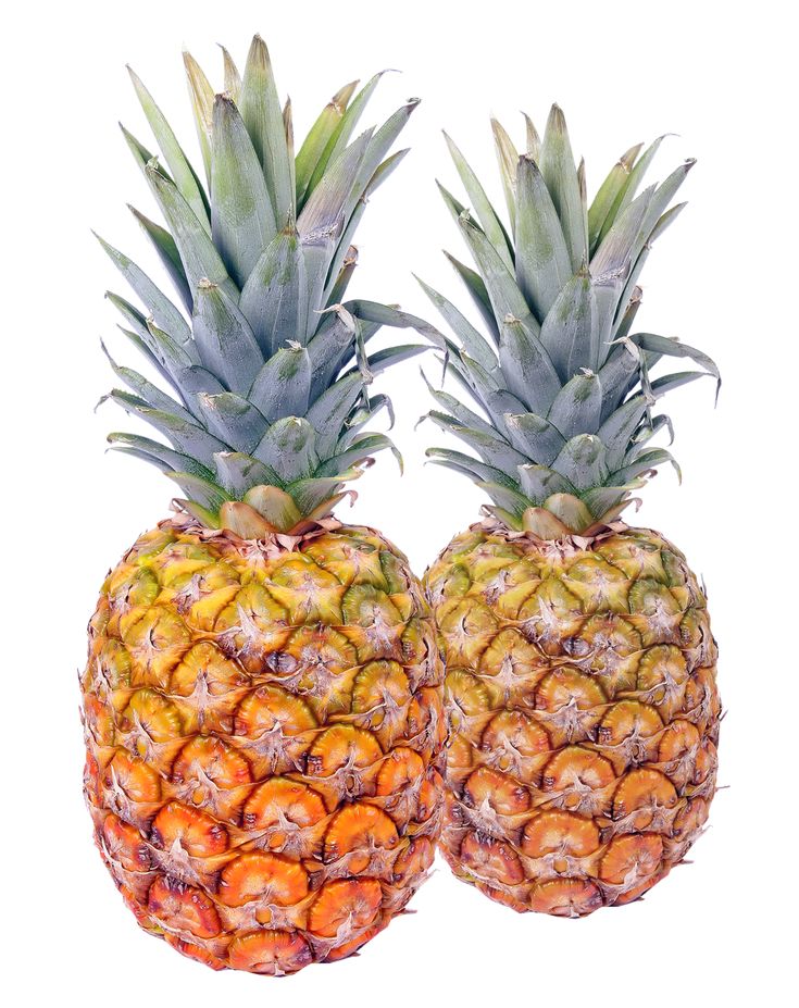 two pineapples sitting next to each other on a white background