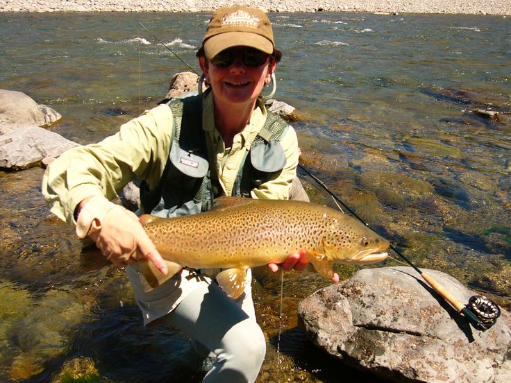 a man holding a brown fish in his hands