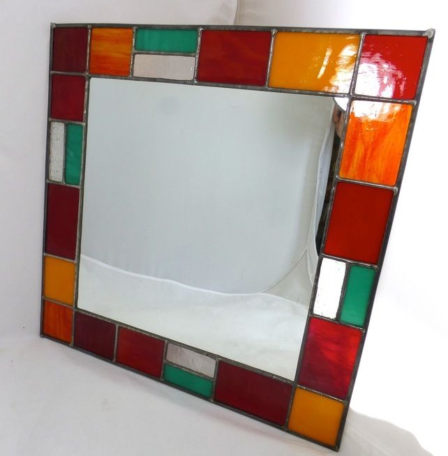 a multicolored mirror sitting on top of a white table